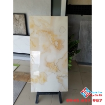 Đá bóng kiếng 60x120 lót nền khắc kim vàng