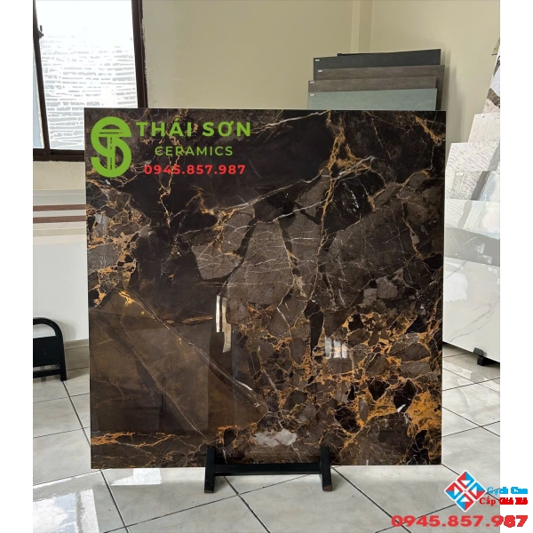 Gạch trung quốc 100x100 xám nâu đường chỉ màu vàng đồng